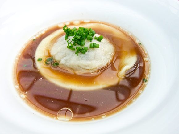 Raviolo with confit garlic and duck neck braised in broth. This was so so so good.